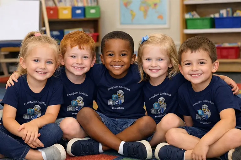Preschool kids sitting in a row